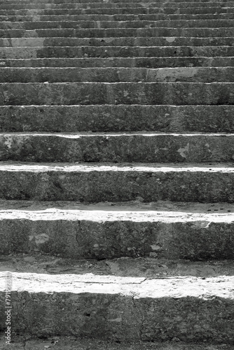 long staircase with gray stone steps that rises towards infinity