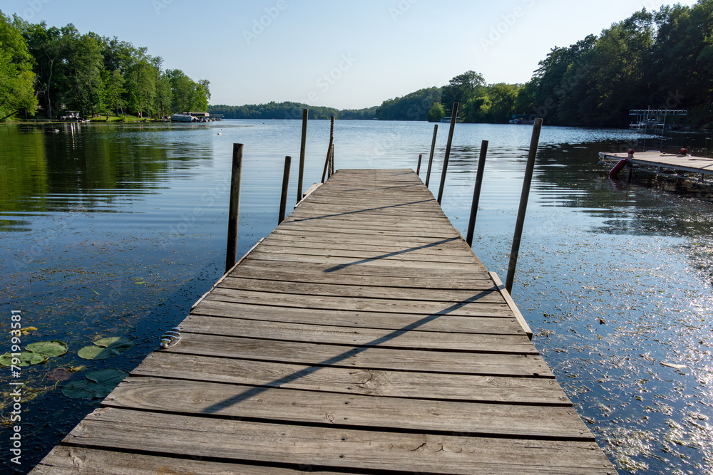 Fototapeta premium Looking down a pier on a lake in northern Wisconsin.