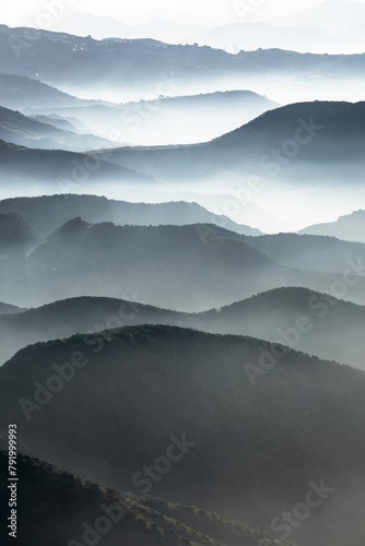 Misty mountain canyon ridges near Porter Ranch and Chatsworth in Los Angeles, California.  Vertical view. © trekandphoto