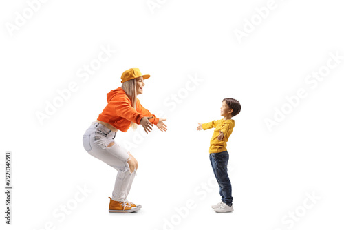 Full length profile shot of a little boy meeting a young female