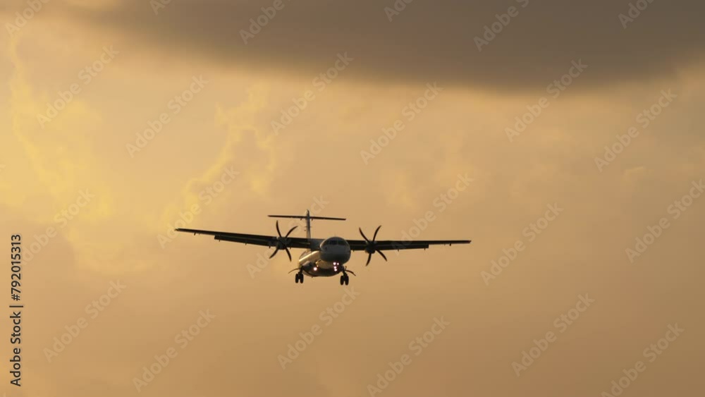 Turboprop aircraft approaching landing, front view. Aircraft in the sky. Jet airliner flying Turboprop aircraft approaching landing, front view. Aircraft in the sky. Jet airliner flying
