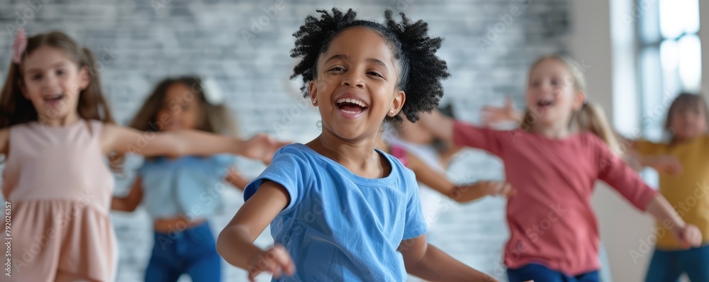 Fototapeta premium Energetic young girl with classmates dancing joyfully in a fitness class.