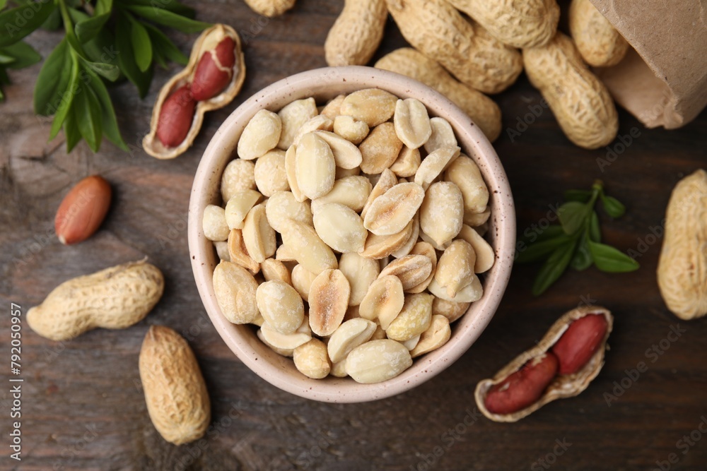Fresh peanuts and leaves on wooden table, flat lay Fresh peanuts and leaves on wooden table, flat lay