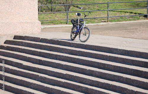 The bike is at the top of a stone staircase