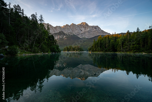 Lake eibsee at dawn with still water reflection