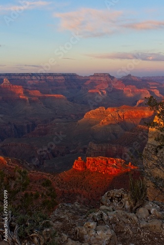 Sunset at the Grand Canyon, Arizona, with rocks glowing red.