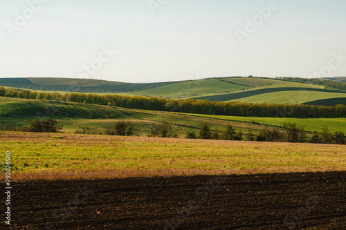 Outdoors landscape shot of green fields and hills in spring on a beautiful sunny day.