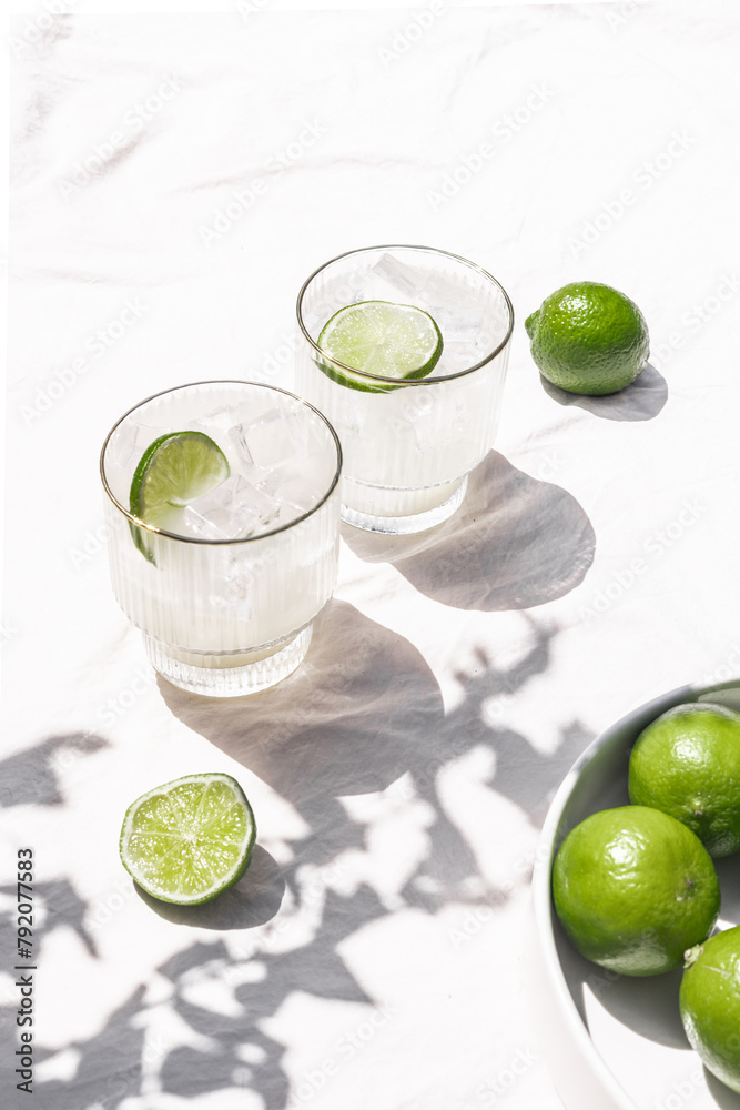 Fototapeta premium Margarita Soda Water Beverage Summertime Cocktail with Lime on Solid Bright White Background