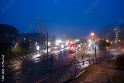 Tram stop on a foggy night.