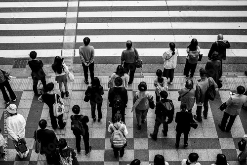 大阪梅田の繁華街で横断歩道で信号待ちをする人々。モノクロで撮影 photo