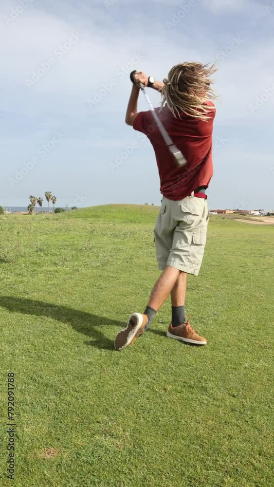 Stylish golfer with dreadlocks during a swing Stylish golfer with dreadlocks during a swing