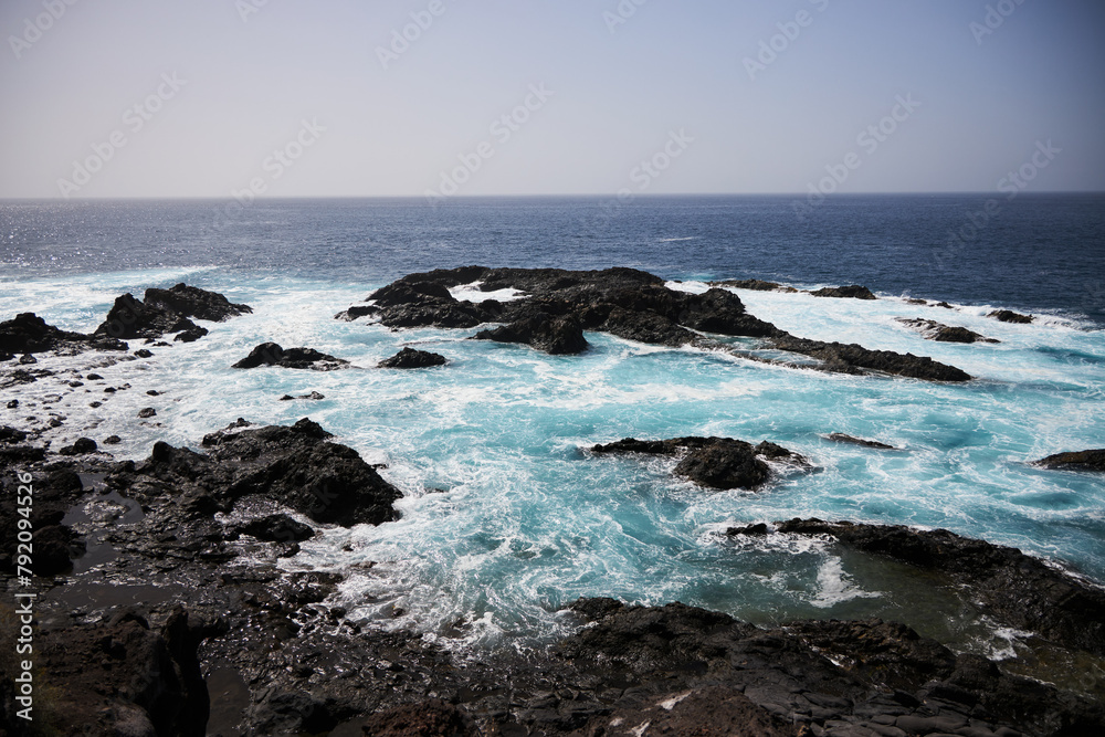 Black bay with blue ocean in Tenerife,  black voulcanic sand