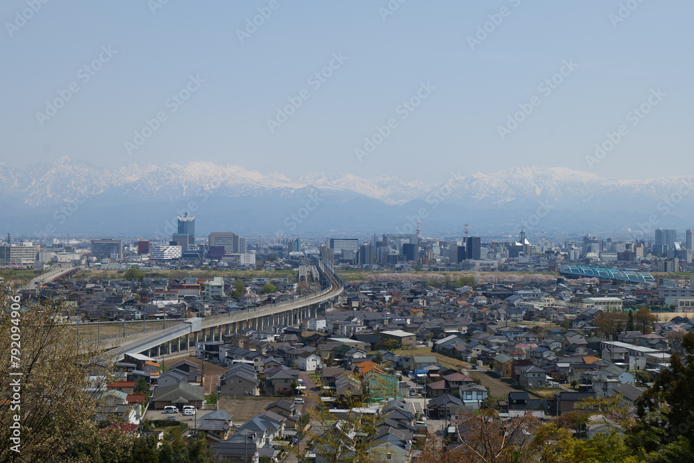 Fototapeta premium 満開の桜春霞の薬師岳北アルプス立山連峰と神通大橋