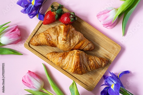 Happy mother's day, beautiful breakfast, lunch with  fresh croissants, strawberries on tray, bouquet of tulips as gift.