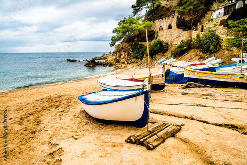 Boats on the beach of Sa Caleta in Lloret de Mar, Catalonia.
 photo