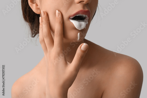 Young woman with white liqu...
