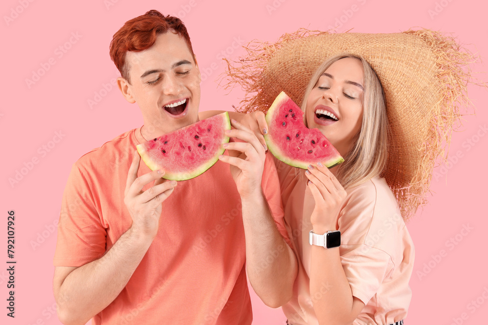 Young beautiful man and woman with slices of fresh watermelon on pink background Young beautiful man and woman with slices of fresh watermelon on pink background