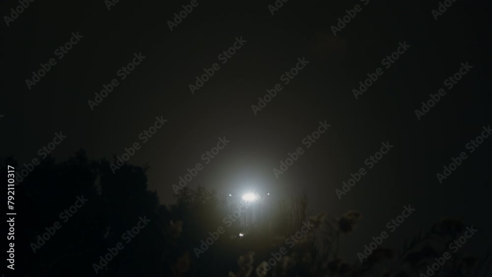 Lights from two airplanes on final approach for landing at night, one behind tree canopy Lights from two airplanes on final approach for landing at night, one behind tree canopy