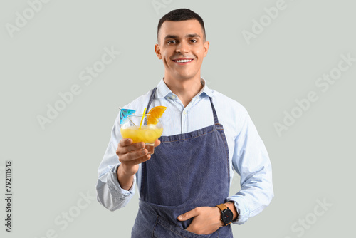 Young male bartender with g...