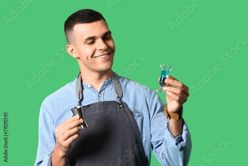 Young male bartender with m...