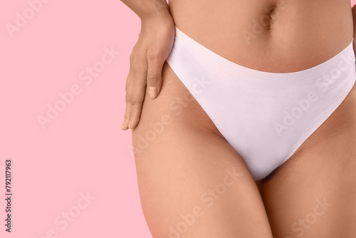 Beautiful young African-American woman with stretch marks on her body against pink background, closeup © Pixel-Shot