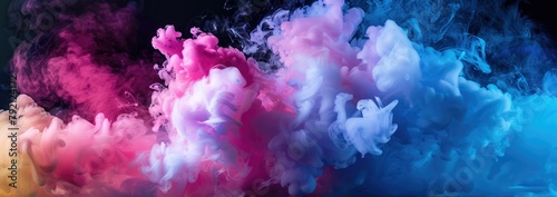Vibrant multicolored smoke clouds merging in a dark background  creating a dynamic and abstract visual effect.