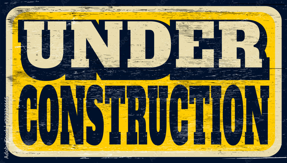Aged and worn under construction sign on wood Aged and worn under construction sign on wood