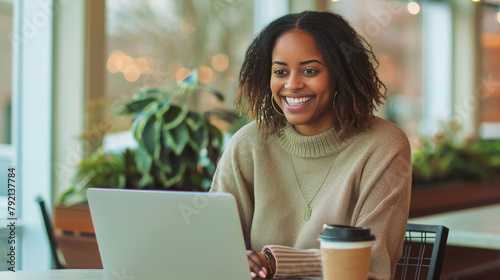 Woman Sitting at Table With Laptop