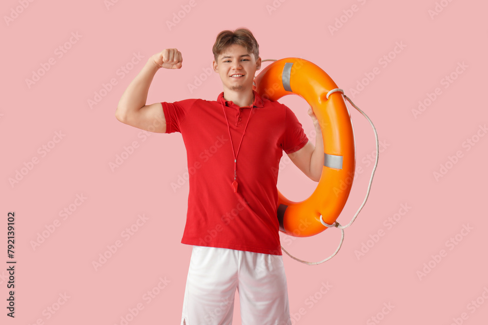 Male lifeguard with lifebuoy ring on pink background Male lifeguard with lifebuoy ring on pink background