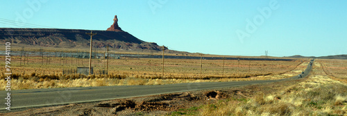 Wide panorama of a road and dramatic rock formation in rural southern Utah