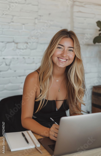 Woman Sitting at Table With Laptop