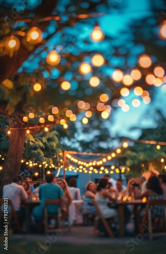 Group of People Sitting at a Table Under a Tree
