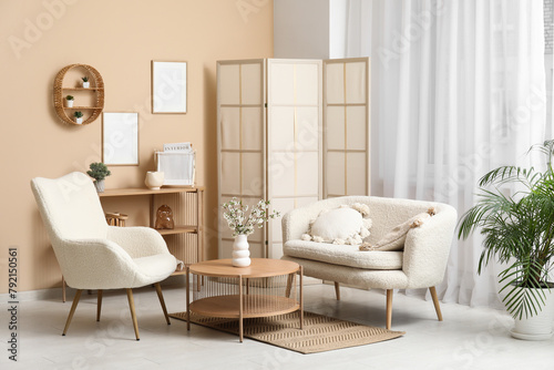 Blooming branches on table in interior of living room