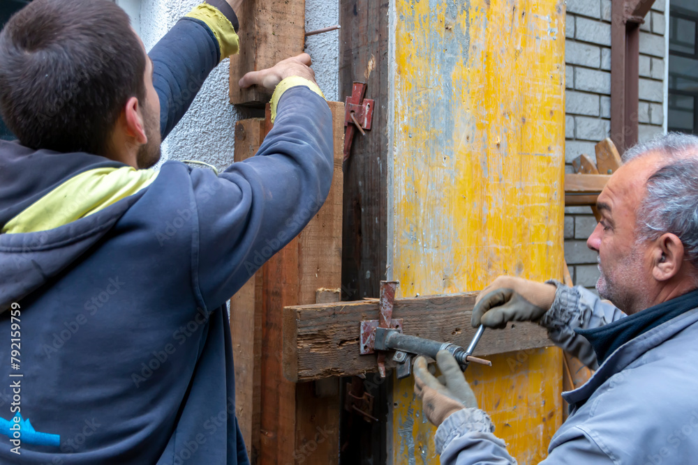 Worker is installing and assembling column formworks for concrete ...