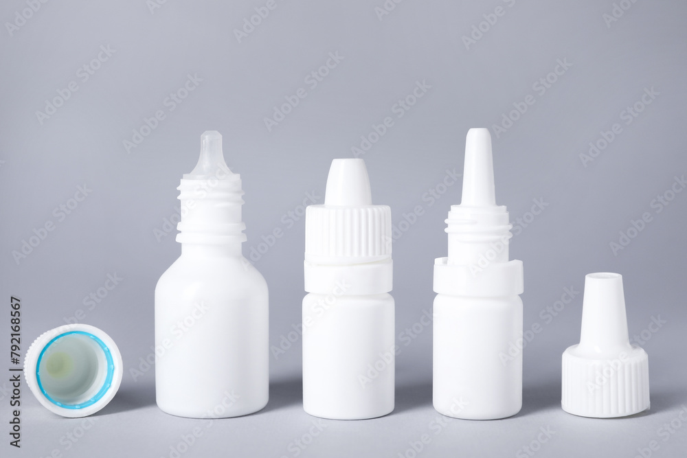Bottles of medical drops on gray background Bottles of medical drops on gray background