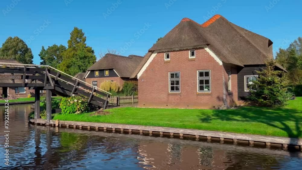 Traditional dutch houses, gardens and water canals and wooden bridges in village is know as Venice of the North. Giethoorn, Netherlands, Julay 30, 2023. High quality 4k footage