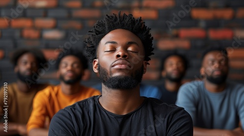 Men Sitting in a Row With Eyes Closed photo
