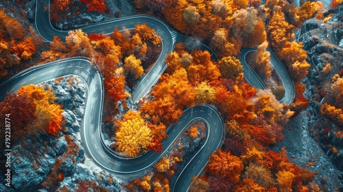 Top-down view of a spiraling mountain road with autumn colors © AI Farm