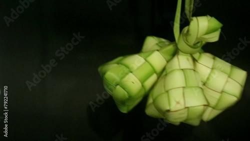 Spinning ketupat and buras, this is a typical traditional Indonesian food which has become part of the people's culture during the Eid season. photo