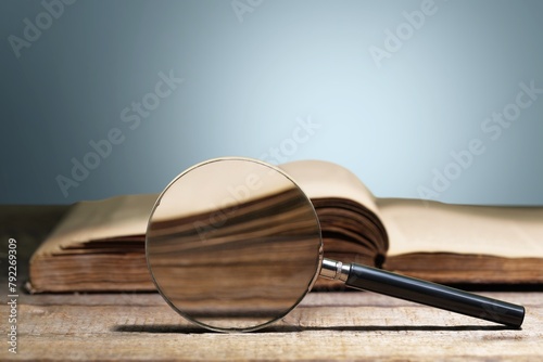 magnifying glass on the page of book, education concept © BillionPhotos.com