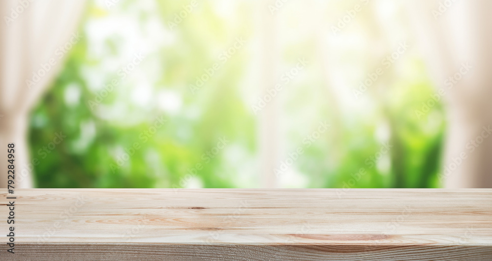 Empty of wood table top on blur of curtain with window view green from tree garden background.For montage product display or design key visual layout Empty of wood table top on blur of curtain with window view green from tree garden background.For montage product display or design key visual layout