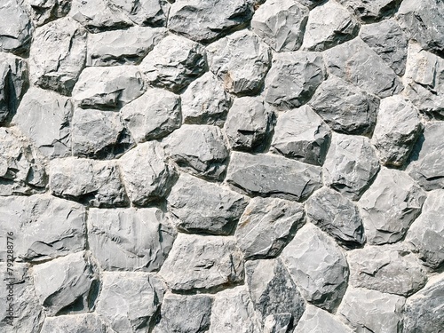 Stacks of rock on the wall in grey tone with texture for background and decoration
