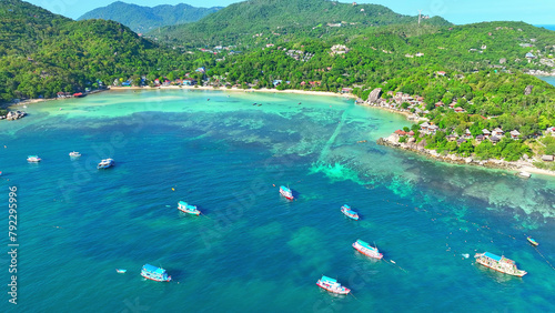 Ship sails amid azure waters as snorkelers explore. A picture-perfect island escape, captured by drone. Aerial view. Ko Tao, Surat Thani Province, Southern Thailand. Nature background. 