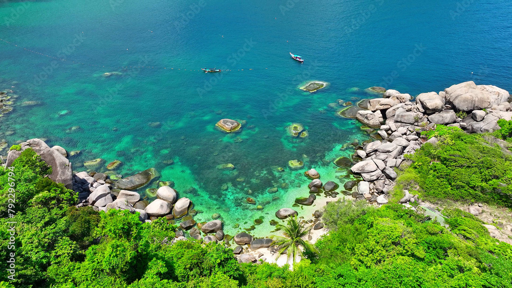 Serene coastline adorned with verdant trees, a solitary coconut palm amidst rocky formations, and pristine azure waves. Drone aerial view. Koh Tao, Surat Thani Province, Southern Thailand.
Serene coastline adorned with verdant trees, a solitary coconut palm amidst rocky formations, and pristine azure waves. Drone aerial view. Koh Tao, Surat Thani Province, Southern Thailand.