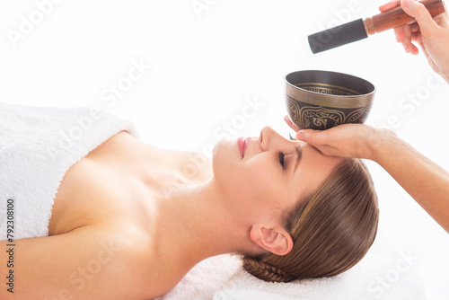 Young woman getting massaging treatment over white. Spa, healthcare and recreation concept. photo