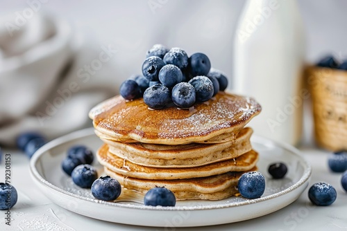 Gluten free pancakes with fresh blueberries on top. Blueberry pancake tower on white round plate. Milk bottle as background. Selective focus - generative ai