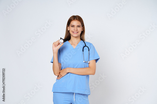 Young doctor woman wearing a stethoscope isolated on white background.
