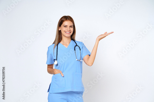 Young doctor woman wearing a stethoscope and showing open hand palm with copy space for product isolated on white background.