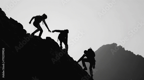 A group of people are climbing a mountain together. The image has a mood of teamwork and camaraderie photo