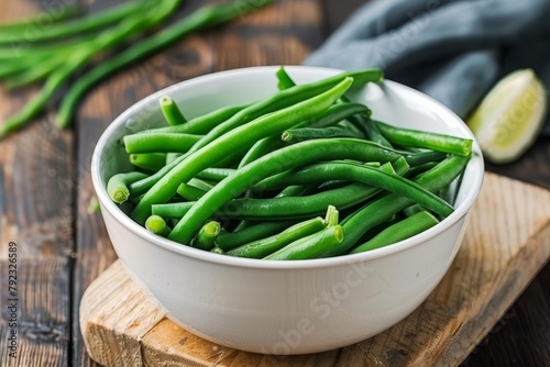 Green beans in a white bowl on a board